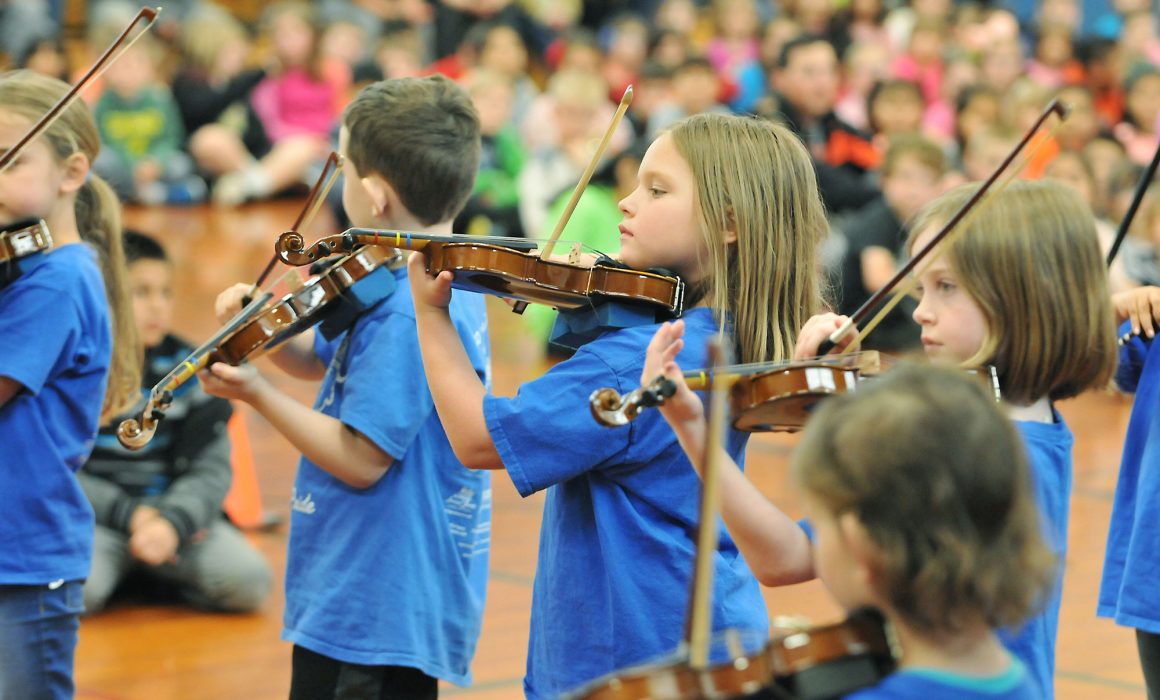 Student musicians playing violins