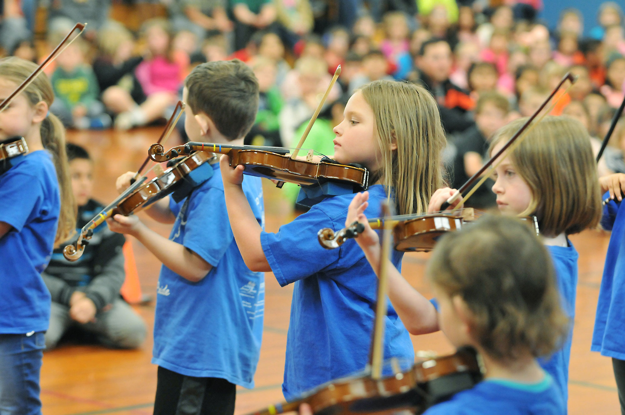 Student musicians playing violins