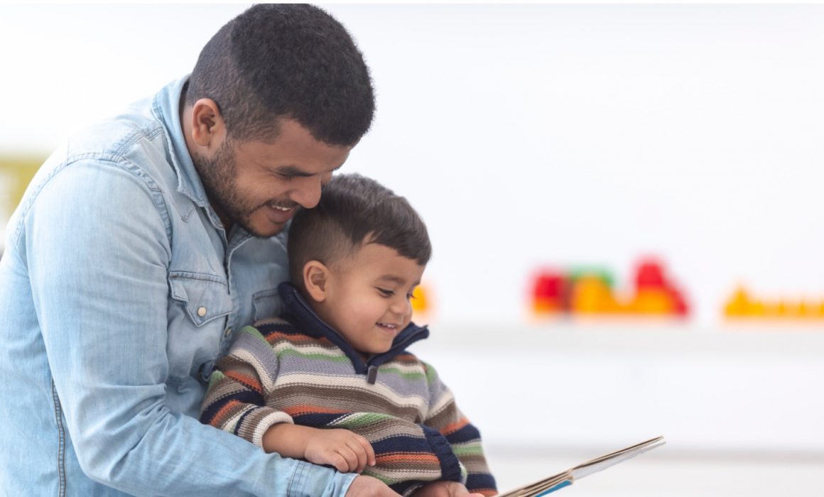 Father and son reading a book