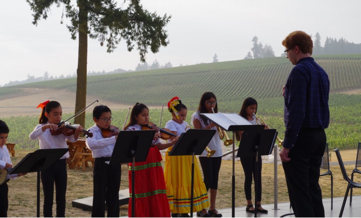 Youth Mariachi band playing at an outdoor event in a vineyard